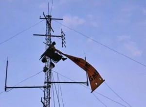 Scott Daines perched on a communications tower near James Price Point